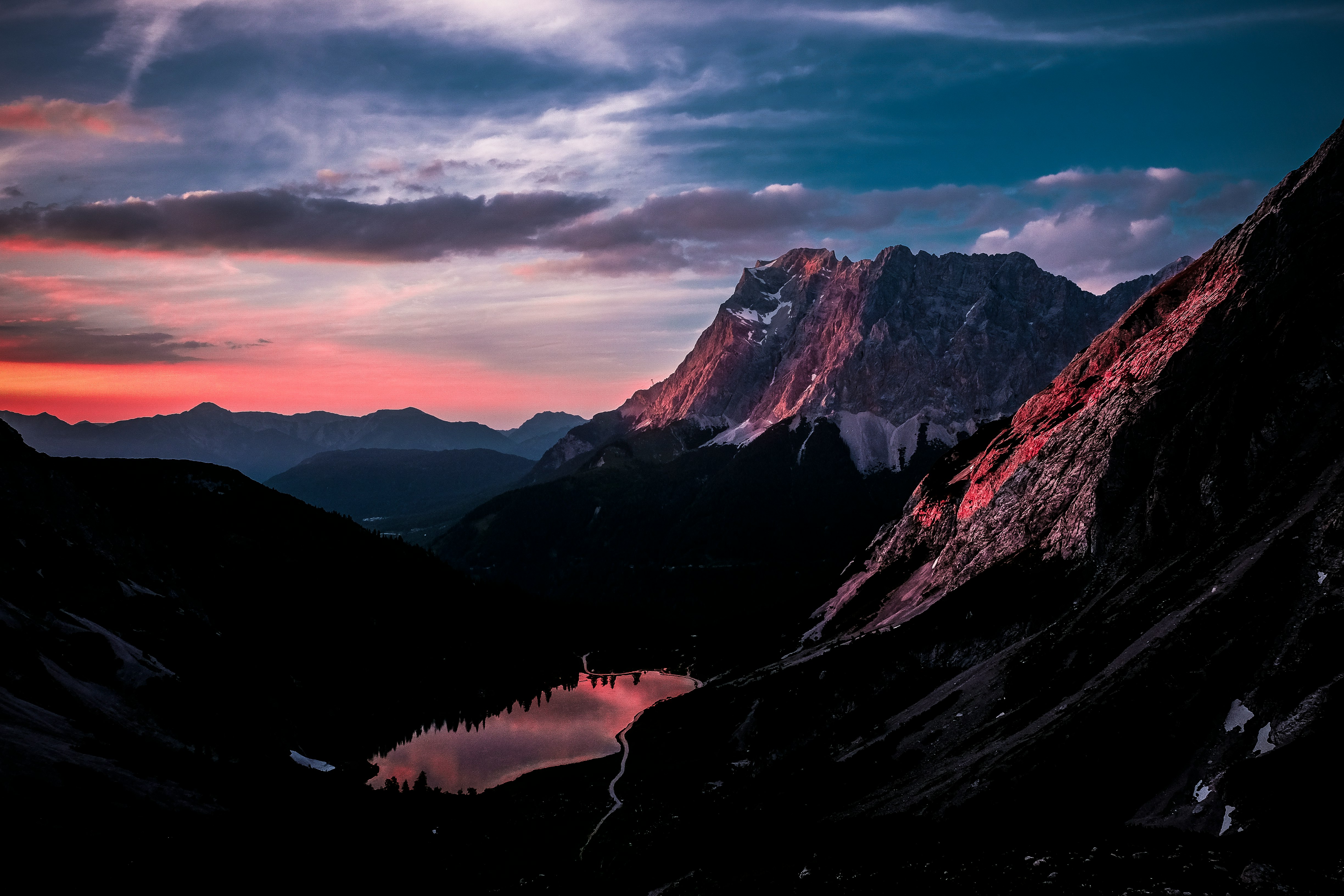 mountains with fog under blue and orange sky